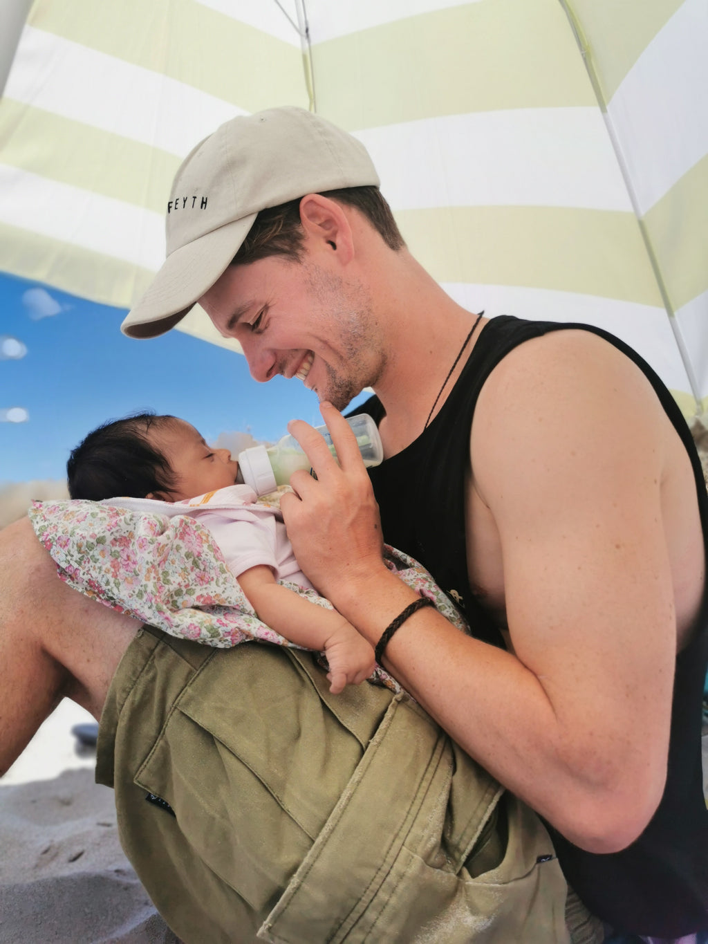 scott feeding baby Bodhi at beach