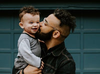 dad kissing kid